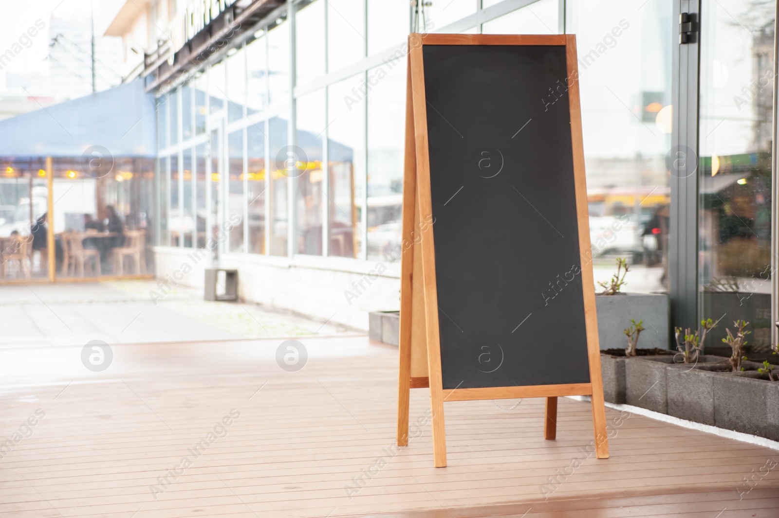 Photo of Empty A-board near building outdoors. Mockup for design