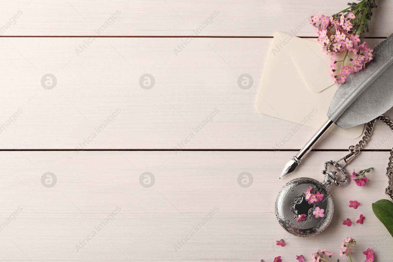 Photo of Flat lay composition with beautiful Forget-me-not flowers on white wooden table. Space for text