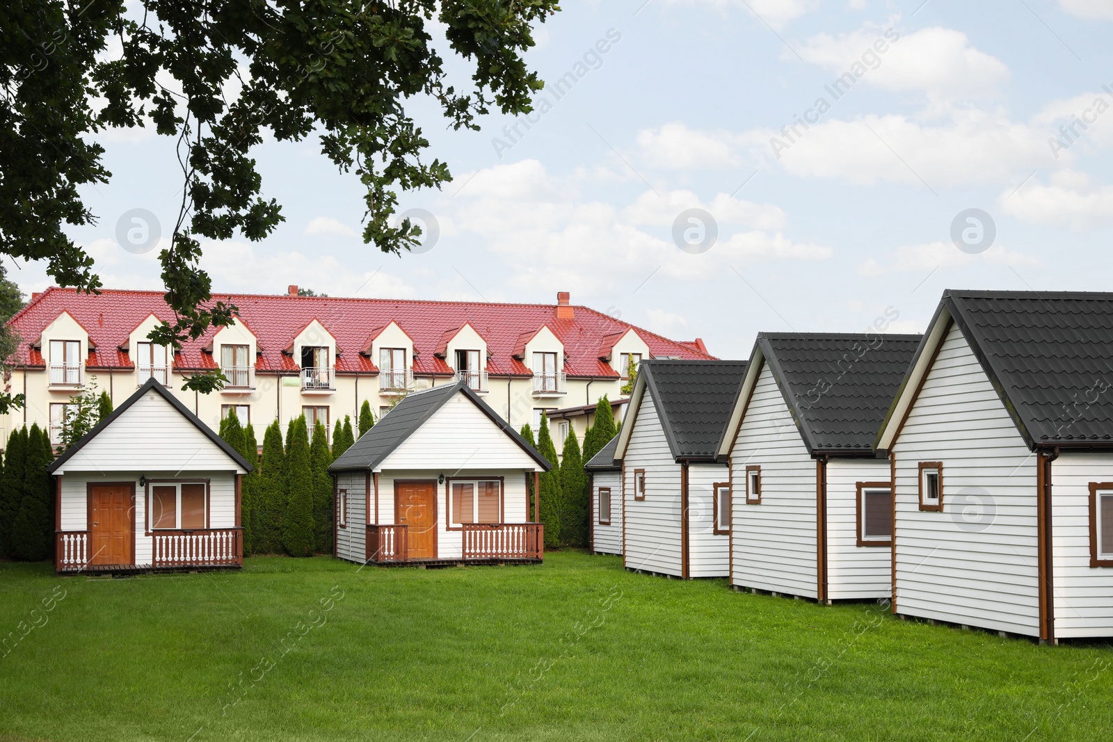 Photo of Beautiful wooden beach houses and green lawn outdoors