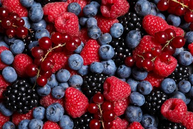Assortment of fresh ripe berries as background, top view
