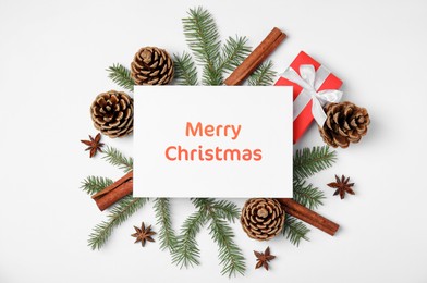 Greeting card with phrase Merry Christmas, beautiful fir tree branches, gift box, pine cones and cinnamon sticks on white background, flat lay