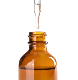 Photo of Dropping herbal essential oil into bottle isolated on white