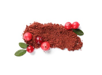 Photo of Dried cranberry powder, fresh berries and green leaves isolated on white, top view