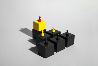 Photo of Cubes with game pieces on light grey background