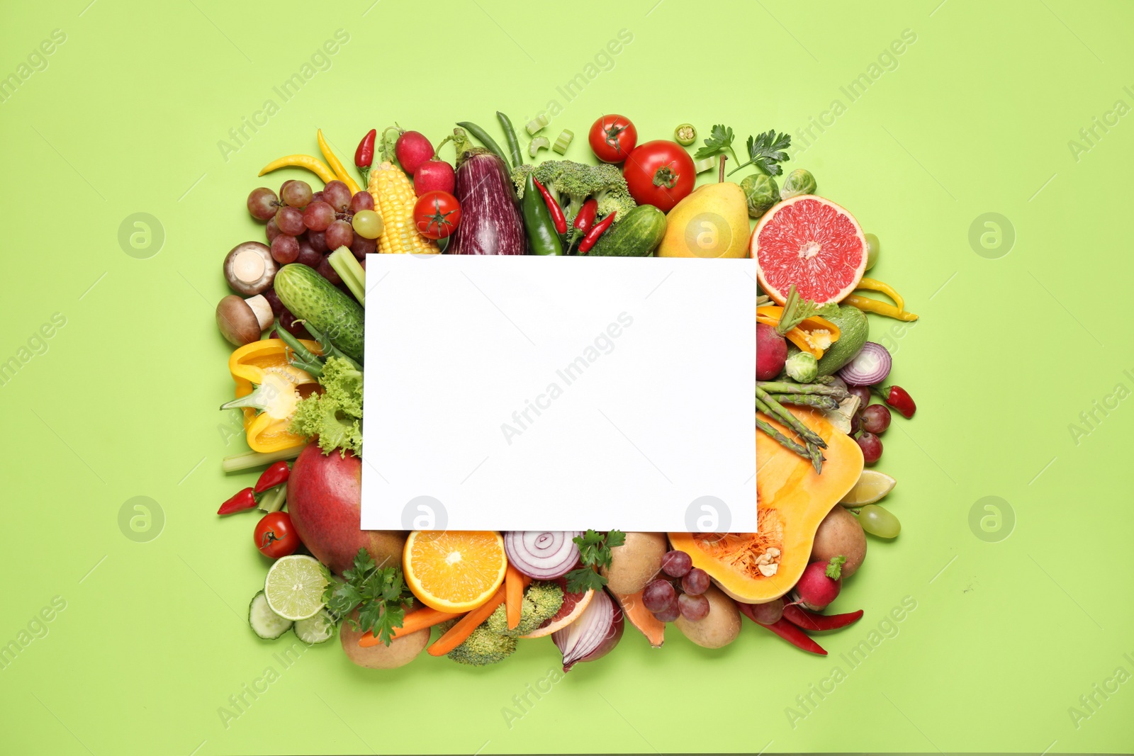 Photo of Fresh organic fruits, vegetables and blank card on green background, flat lay. Space for text