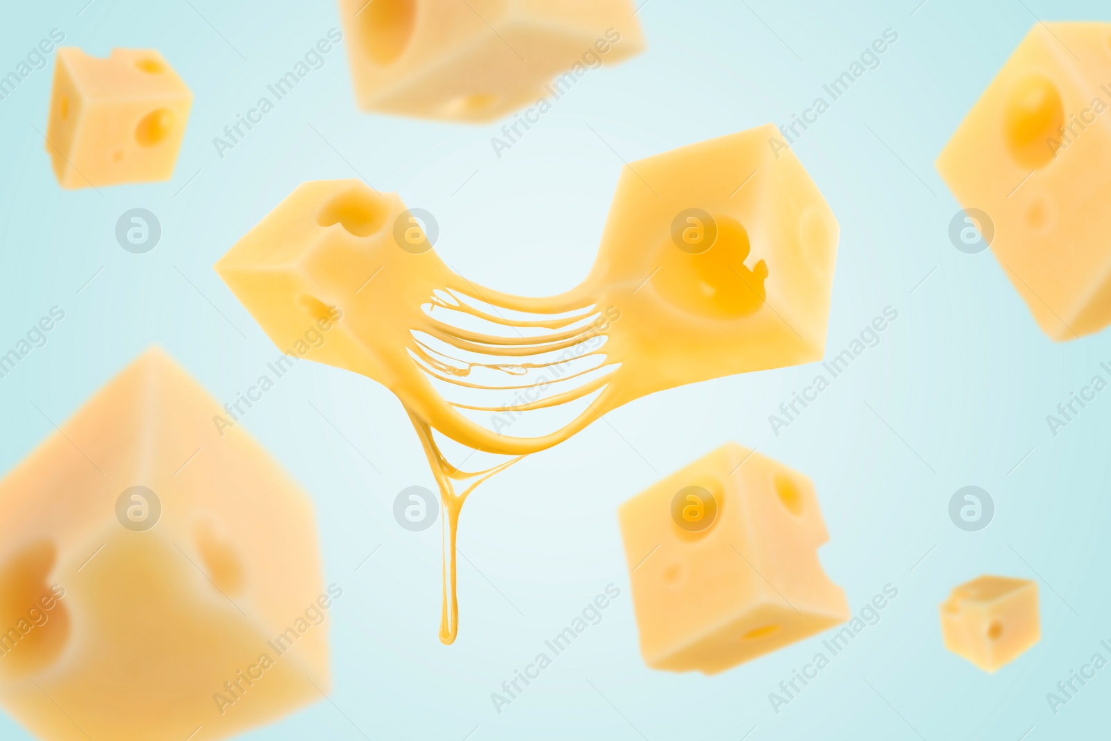 Image of Piecescheese falling on light blue background