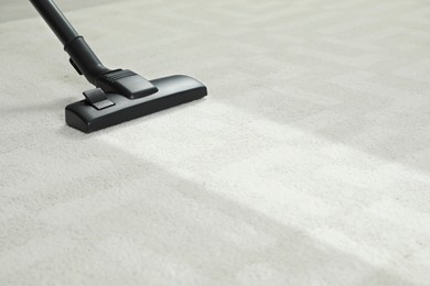 Image of Hoovering carpet with vacuum cleaner, space for text. Clean trace on dirty surface