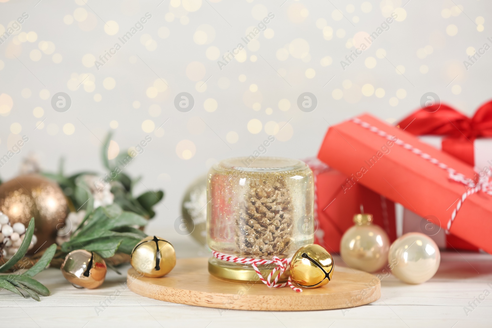 Photo of Handmade snow globe and Christmas decorations on white table