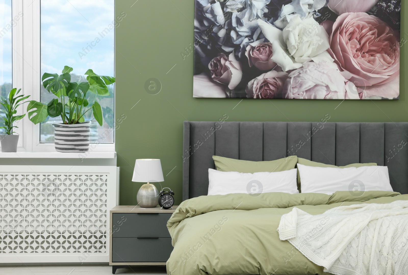 Photo of Comfortable bed and bedside table in bedroom. Stylish interior design