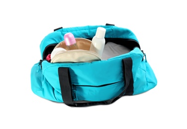 Photo of Sport bag with deodorants and clothes on white background