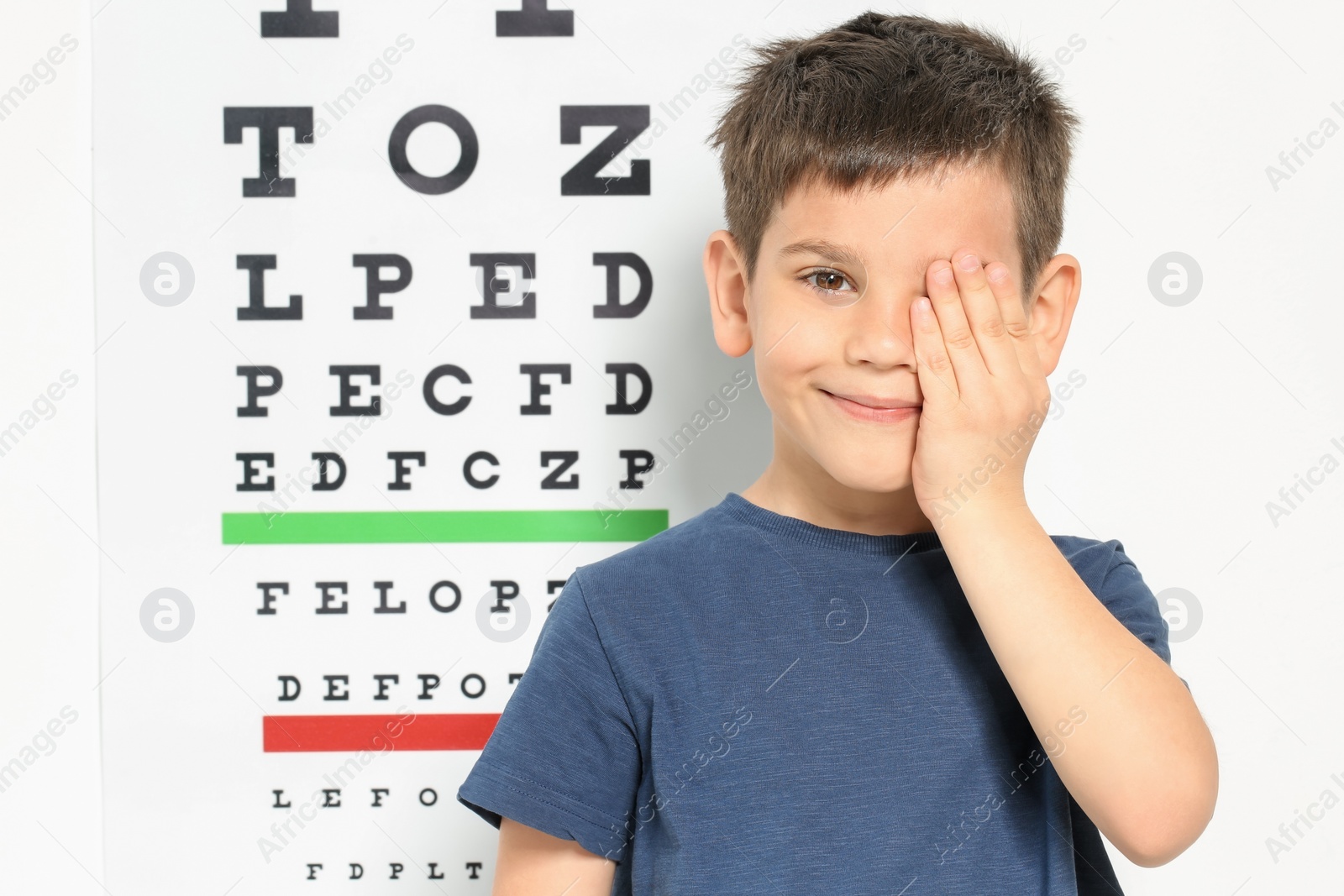 Photo of Cute little boy visiting ophthalmologist