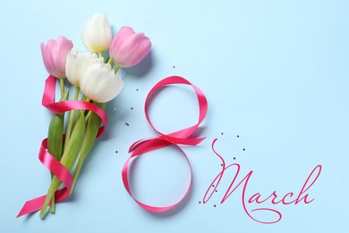 Image of 8 March - Happy International Women's Day. Greeting card design with bouquet of flowers and ribbon on light blue background, top view