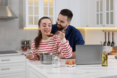 Happy lovely couple cooking together in kitchen