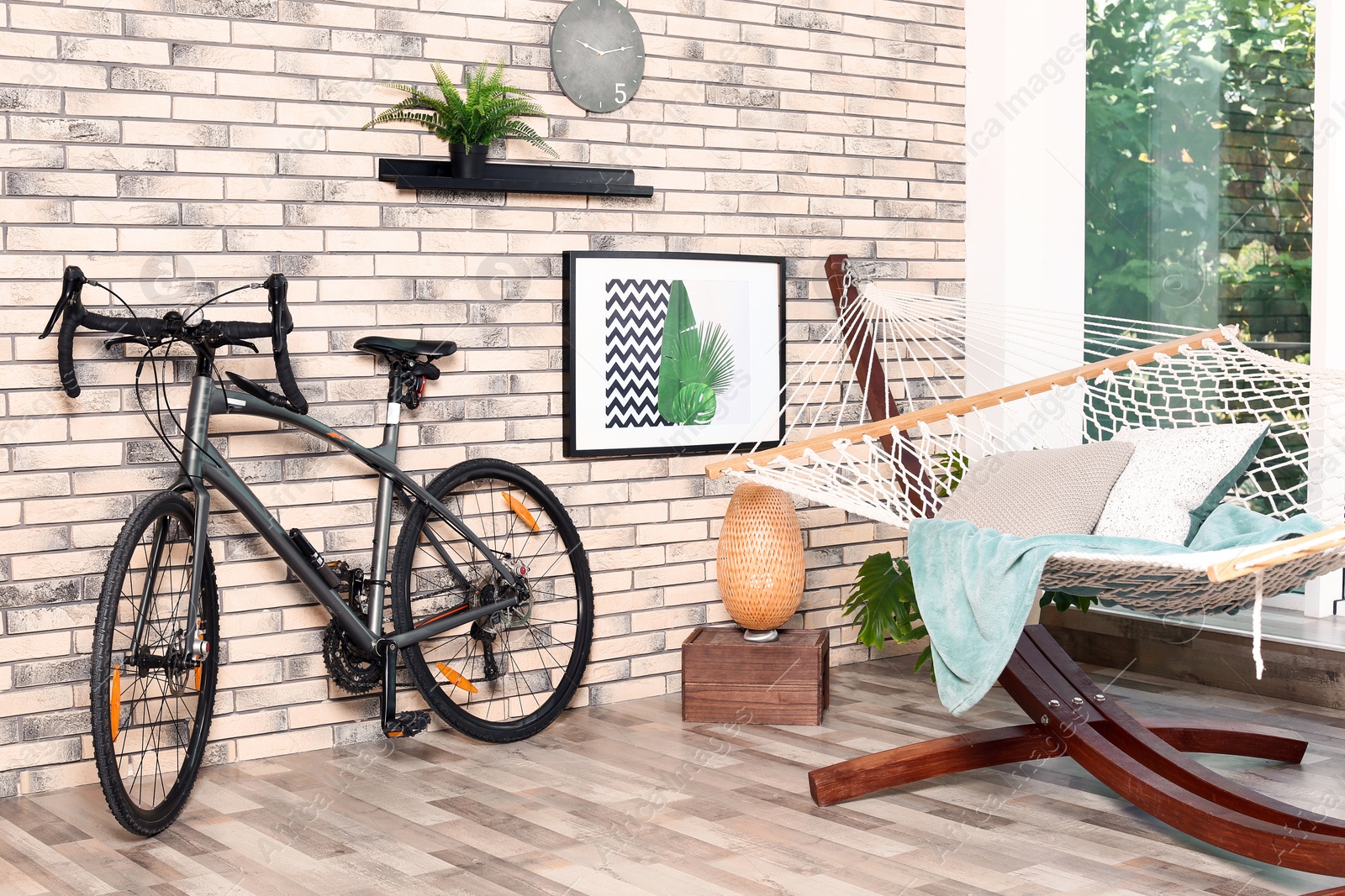 Photo of Modern bicycle and hammock in stylish room interior