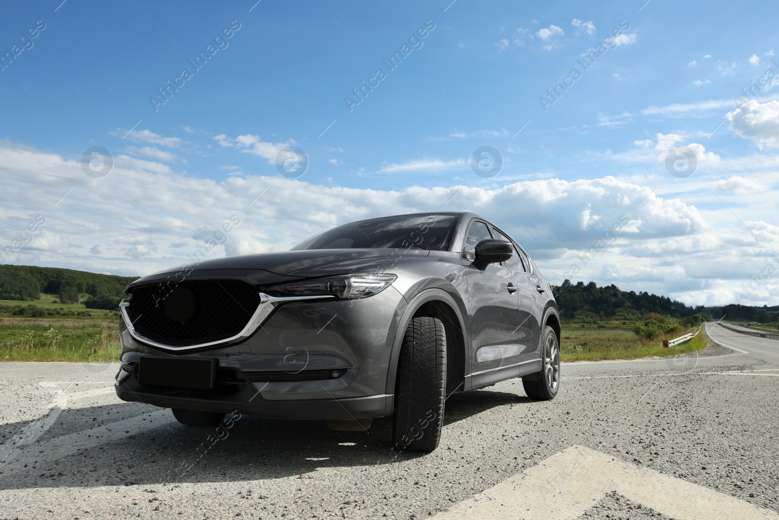 Photo of New black modern car parked outdoors, low angle view