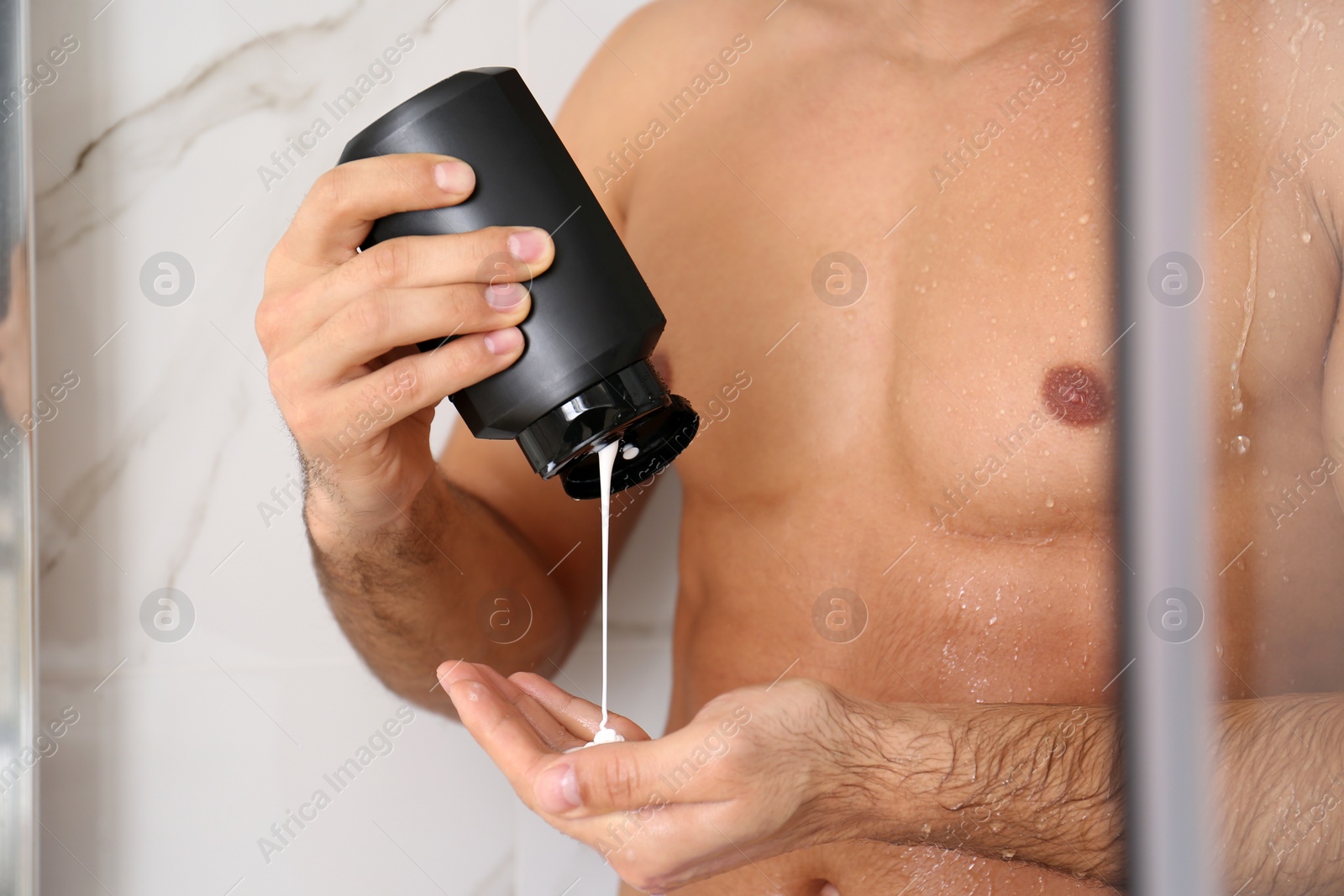 Photo of Man applying gel in shower at home, closeup