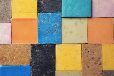 Photo of Different handmade soap bars as background, top view