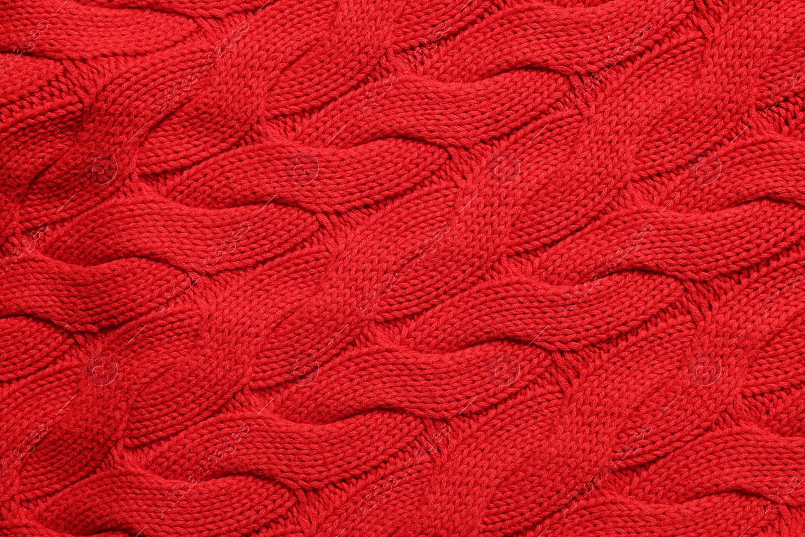 Photo of Texture of soft red knitted fabric as background, top view