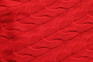 Photo of Texture of soft red knitted fabric as background, top view