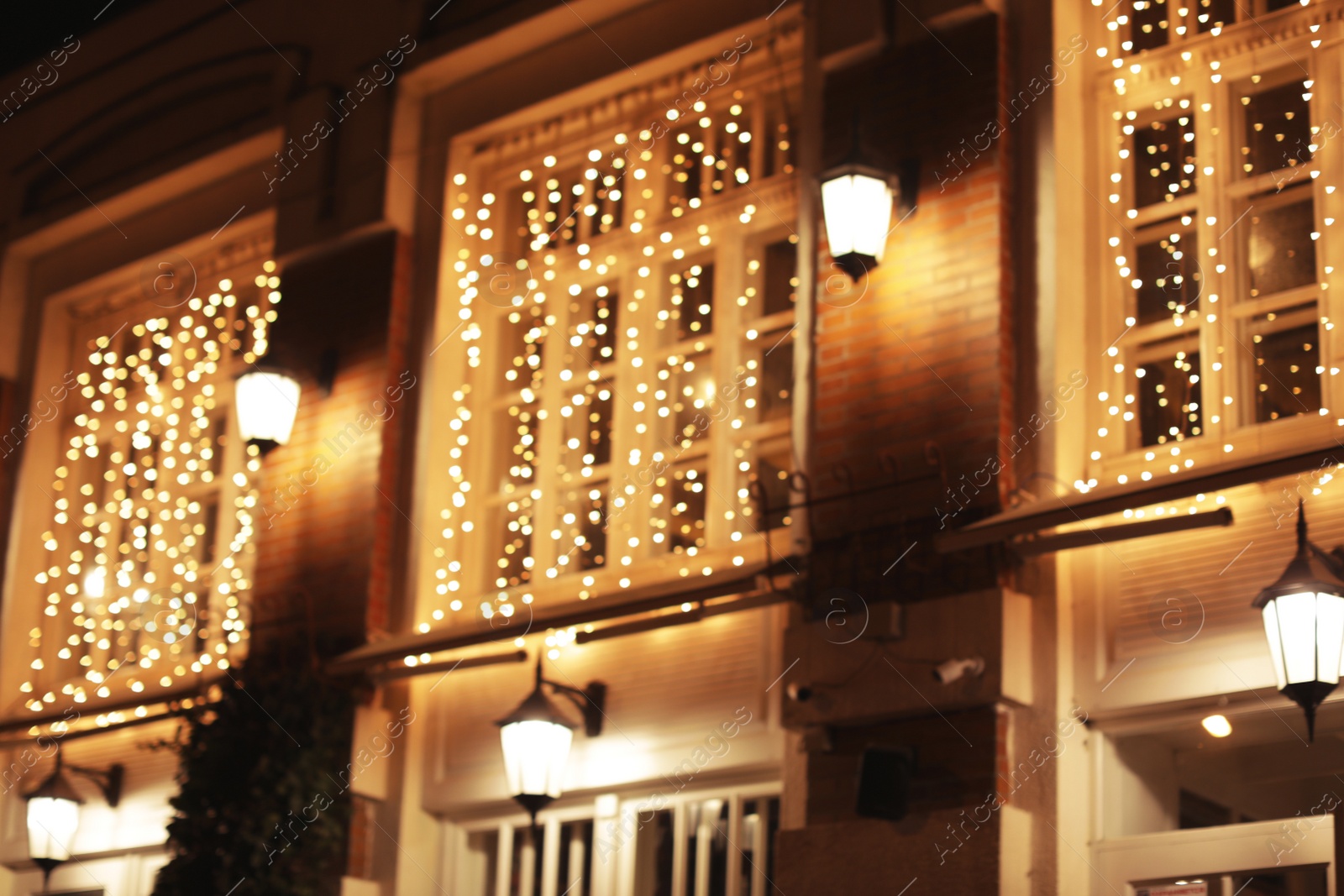 Photo of Blurred view of building with beautiful street lights at night. Bokeh effect