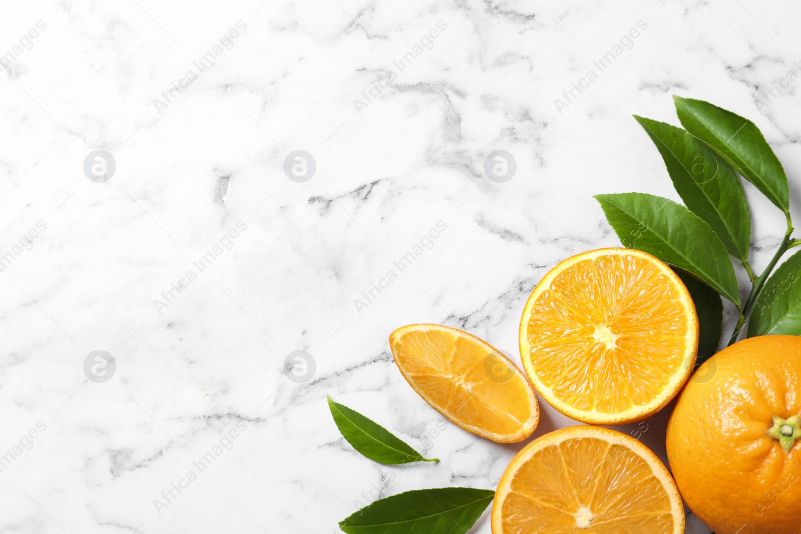 Photo of Flat lay composition with ripe oranges and space for text on marble background