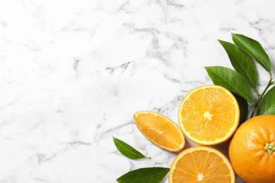 Flat lay composition with ripe oranges and space for text on marble background