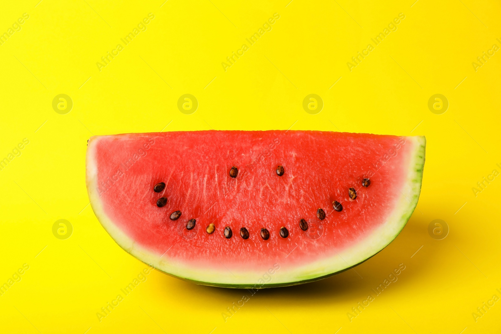 Photo of Watermelon with funny smiling face on color background