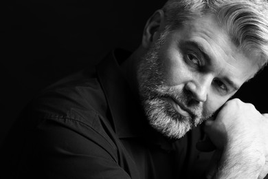 Portrait of handsome man on dark background. Black and white effect