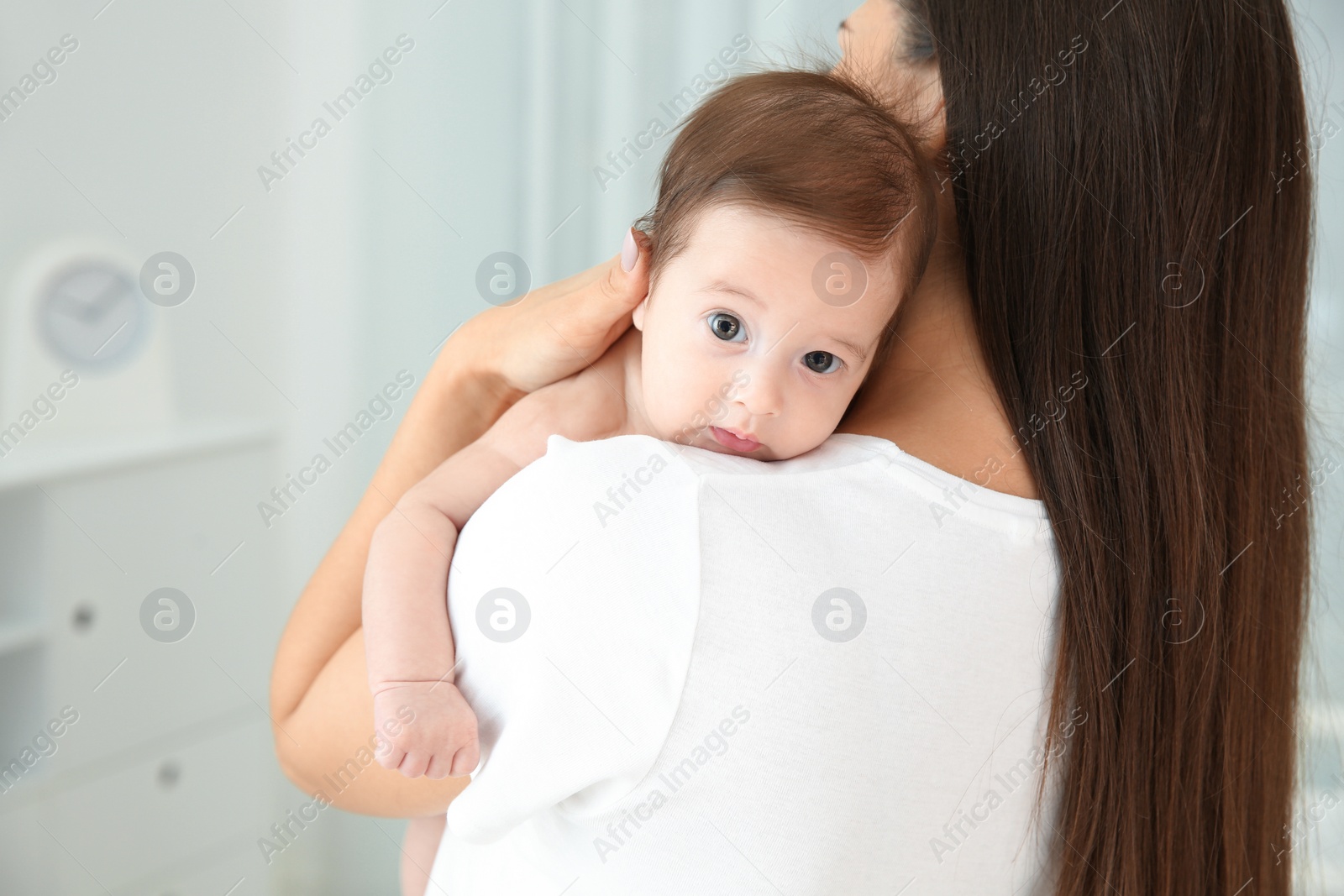 Photo of Woman holding her baby at home, closeup