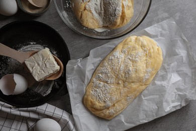 Photo of Dough, eggs and flour on light grey table, flat lay. Cooking ciabatta