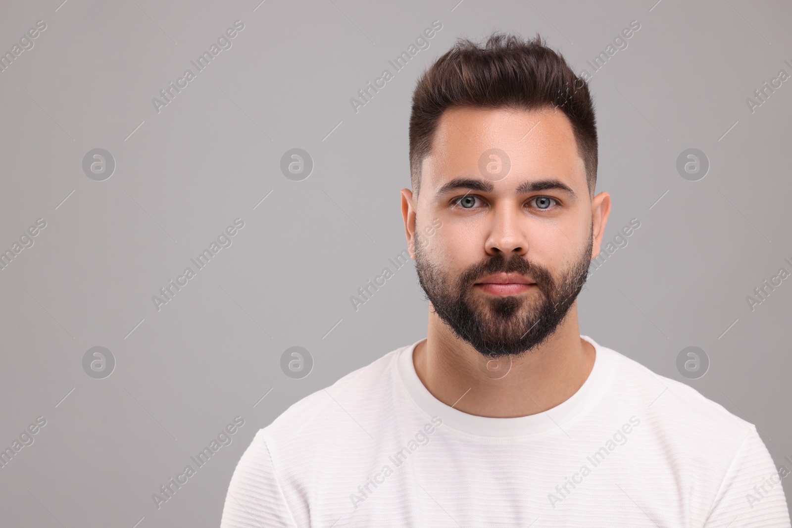 Photo of Portrait of young man on light grey background, space for text