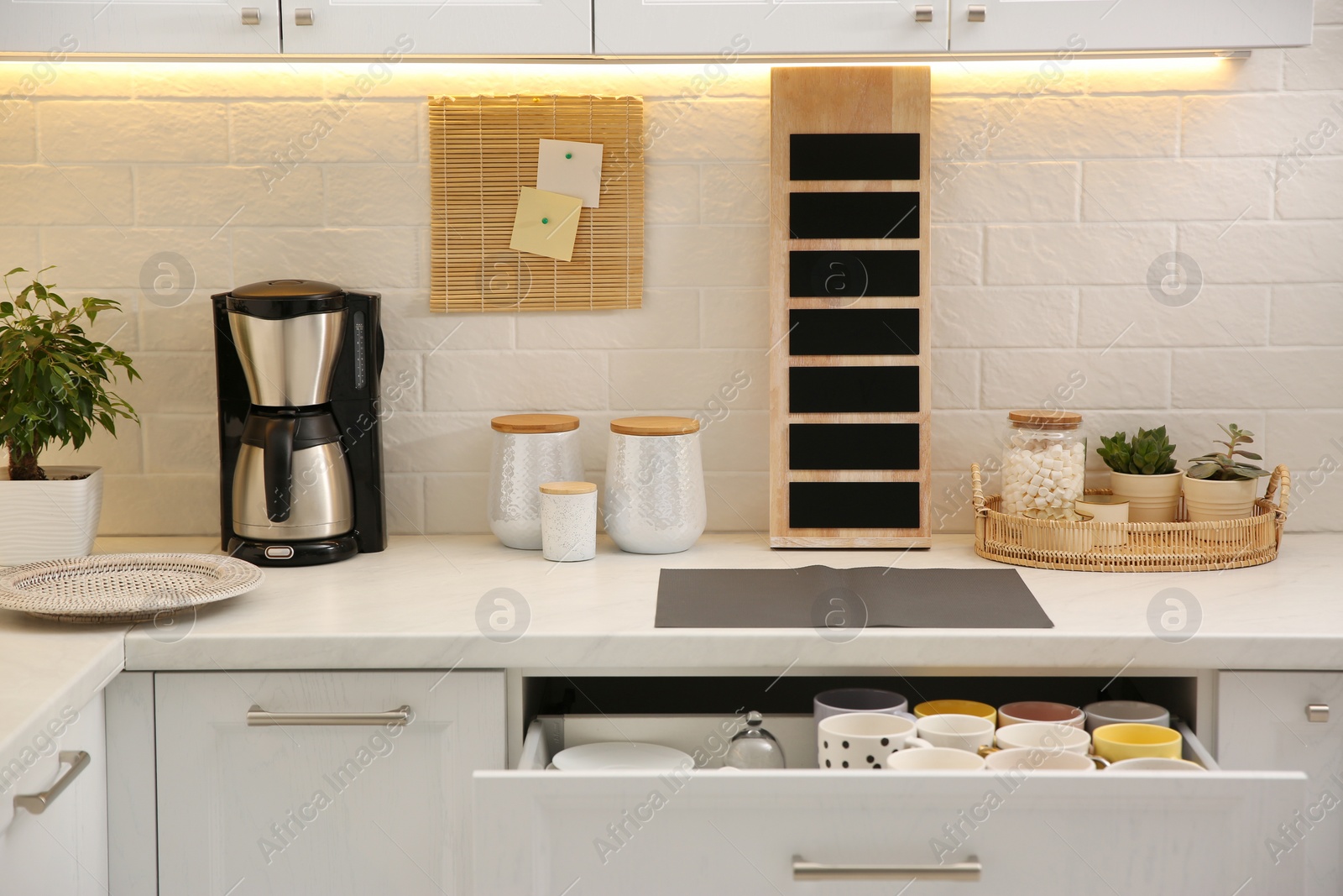 Photo of Stylish kitchen interior with modern coffeemaker on countertop