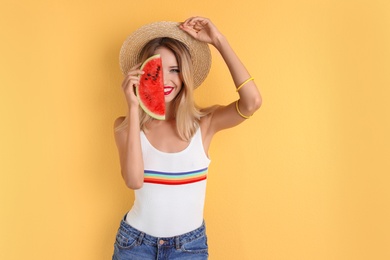 Pretty young woman with juicy watermelon on color background