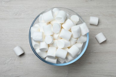 Photo of Delicious puffy marshmallows on wooden table, flat lay