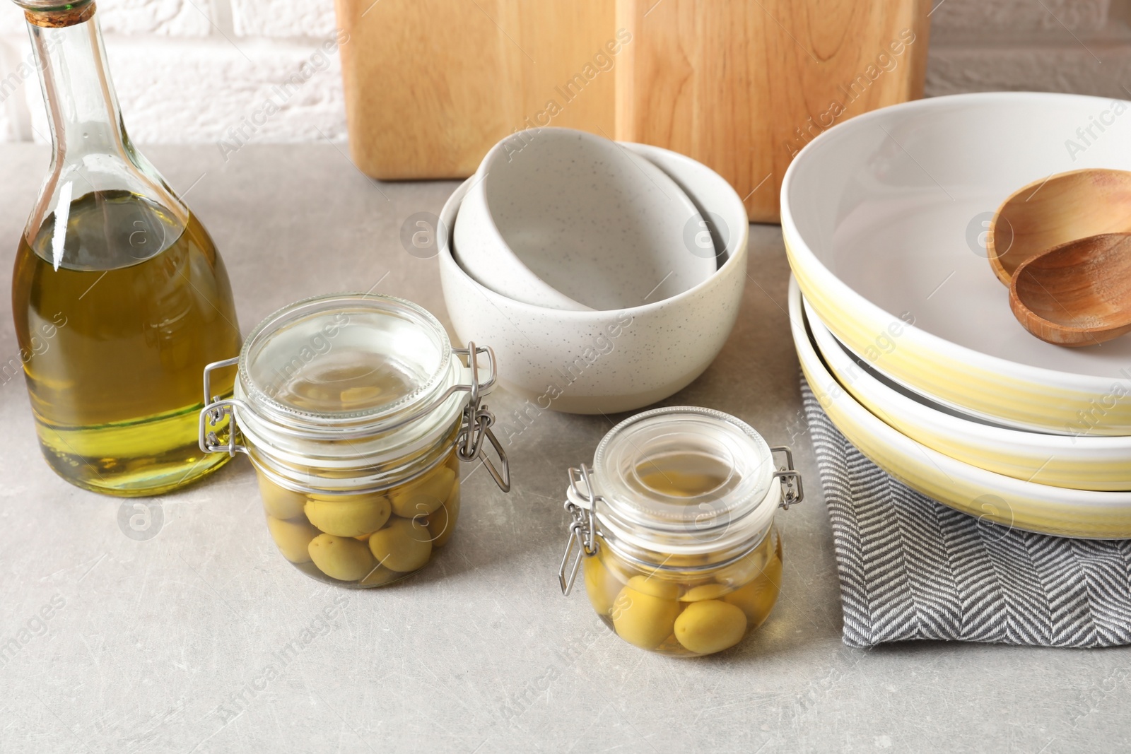 Photo of Beautiful composition with olives in fresh oil on table