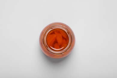 Photo of Tasty canned sliced apricots on white background, top view