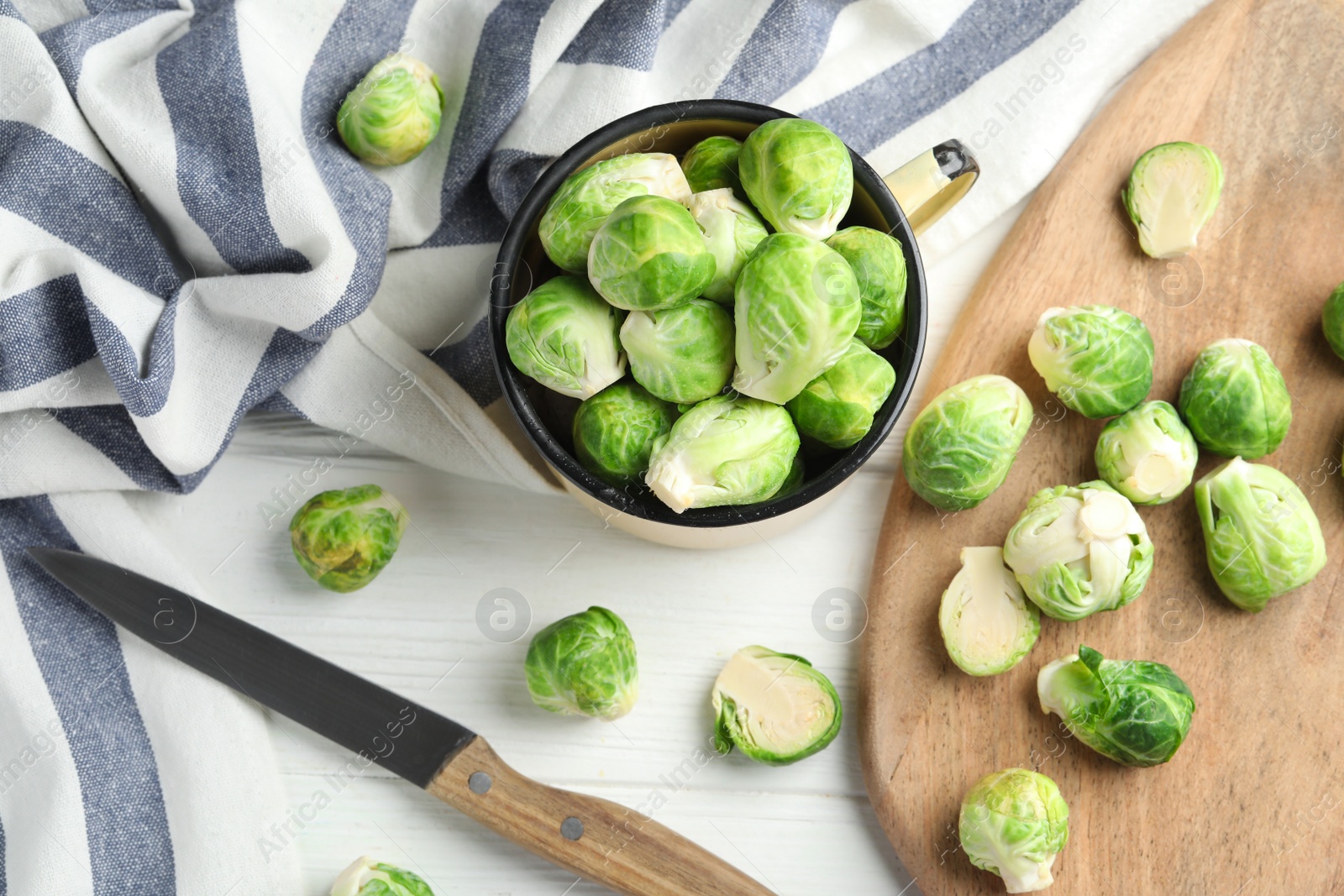 Photo of Fresh Brussels sprouts on white wooden table, flat lay