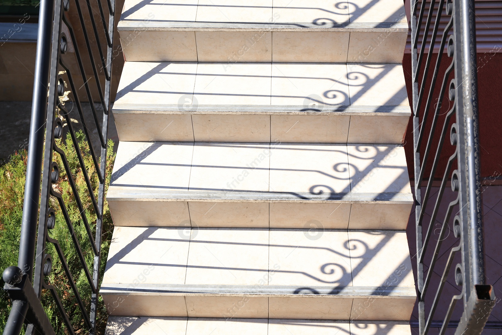 Photo of Beautiful stone stairs with metal handrails outdoors