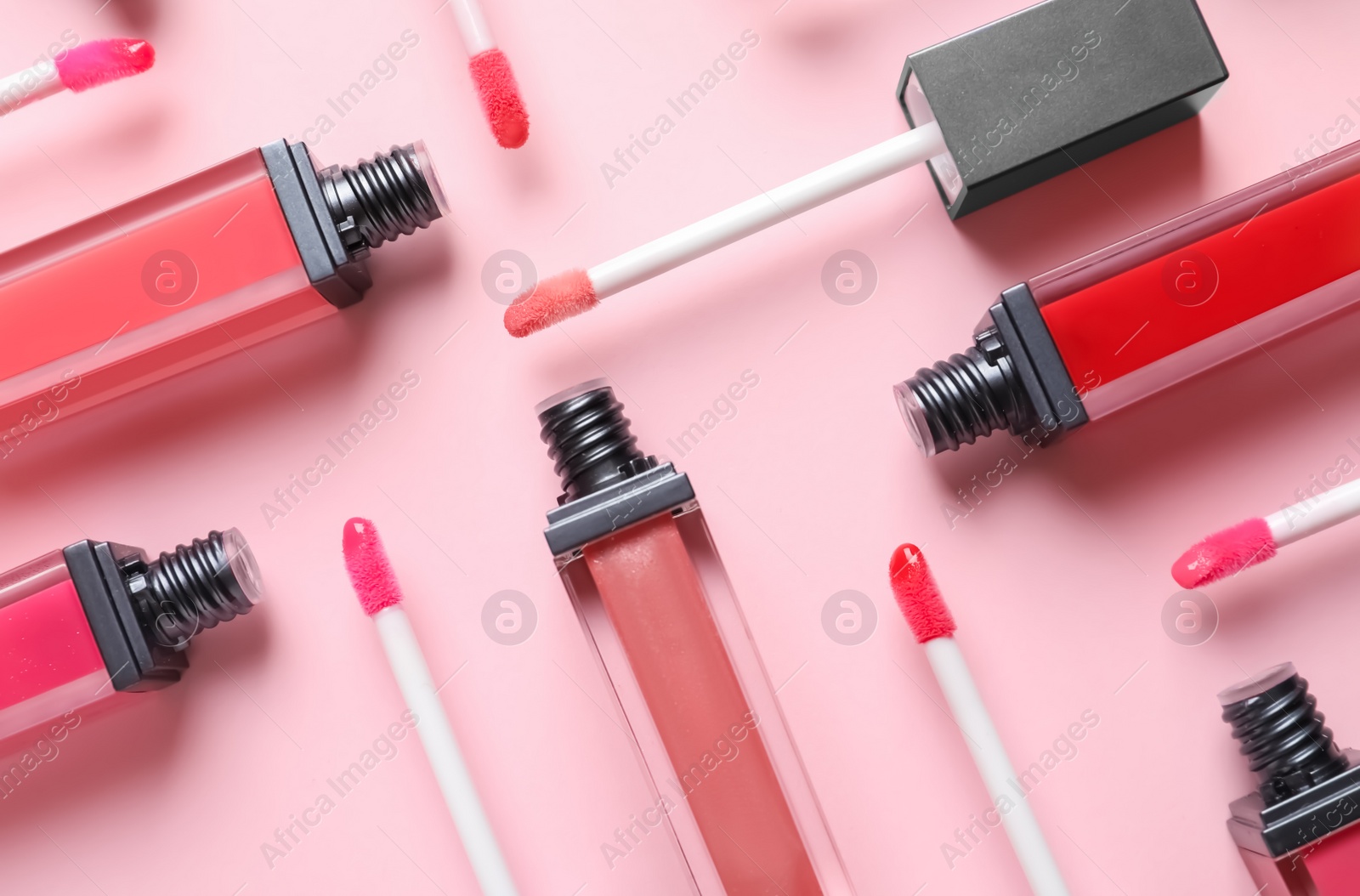 Photo of Composition of liquid lipsticks on color background, flat lay