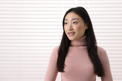 Portrait of smiling businesswoman in office. Space for text