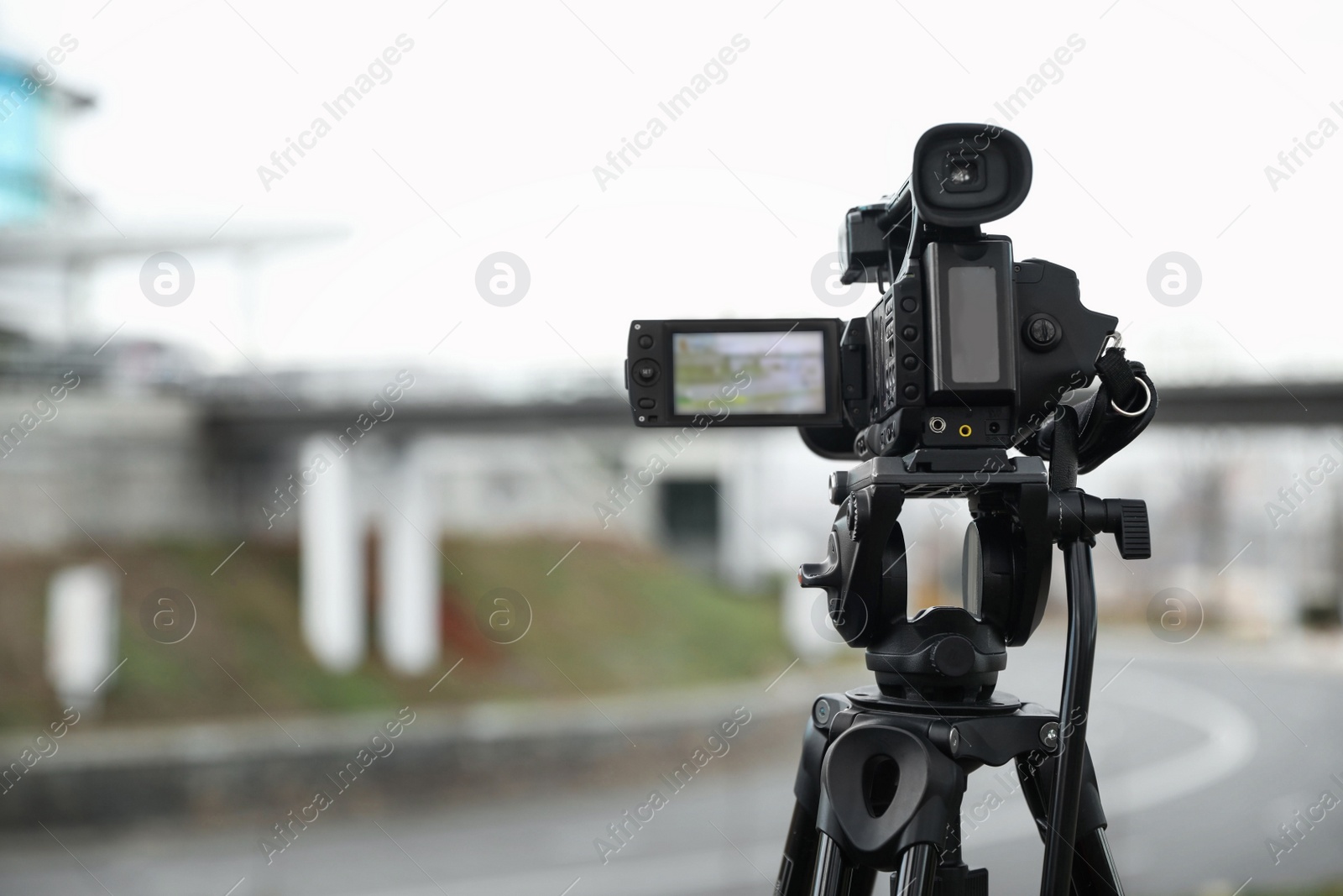 Photo of Professional video camera outdoors. Space for text