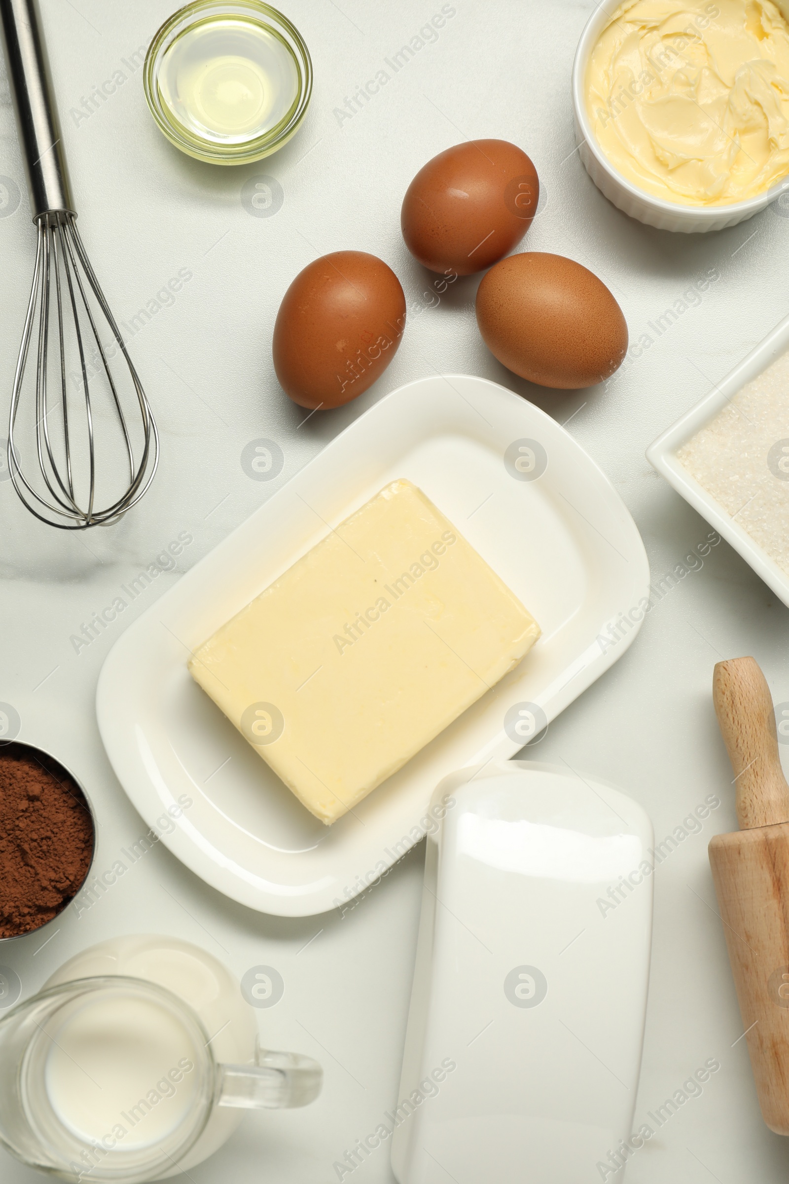 Photo of Flat lay composition with fresh butter among other products on white table