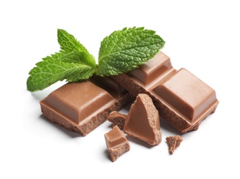 Pieces of milk chocolate with mint on white background