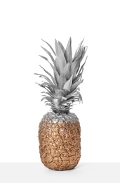 Pineapple painted with silver and gold on white background