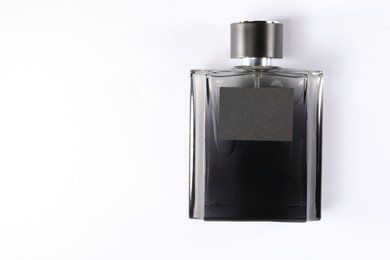 Luxury men`s perfume in bottle on white background, top view. Space for text