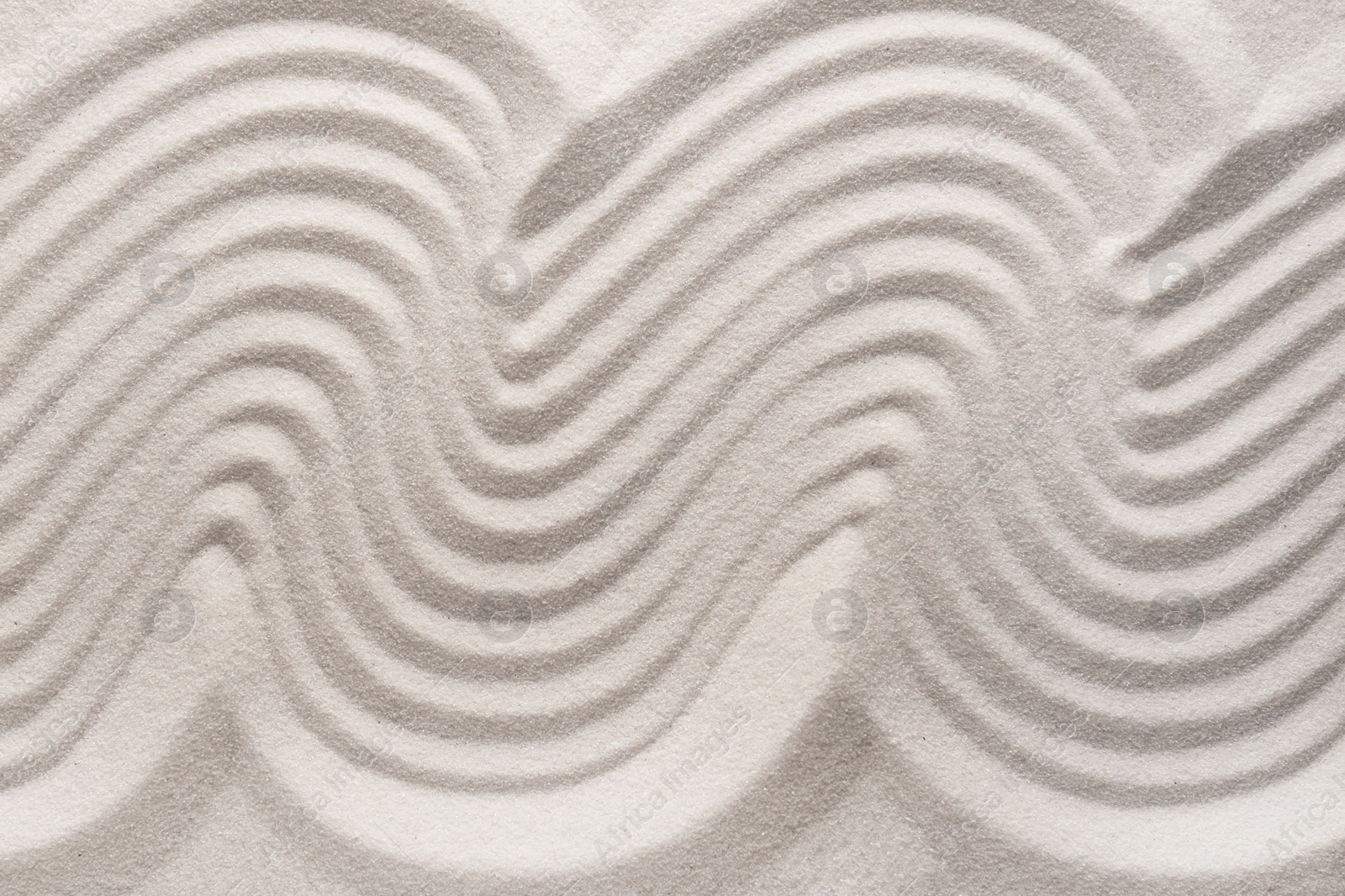 Photo of White sand with pattern as background, top view. Concept of zen and harmony