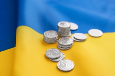 Photo of Ukrainian money on national flag, closeup view