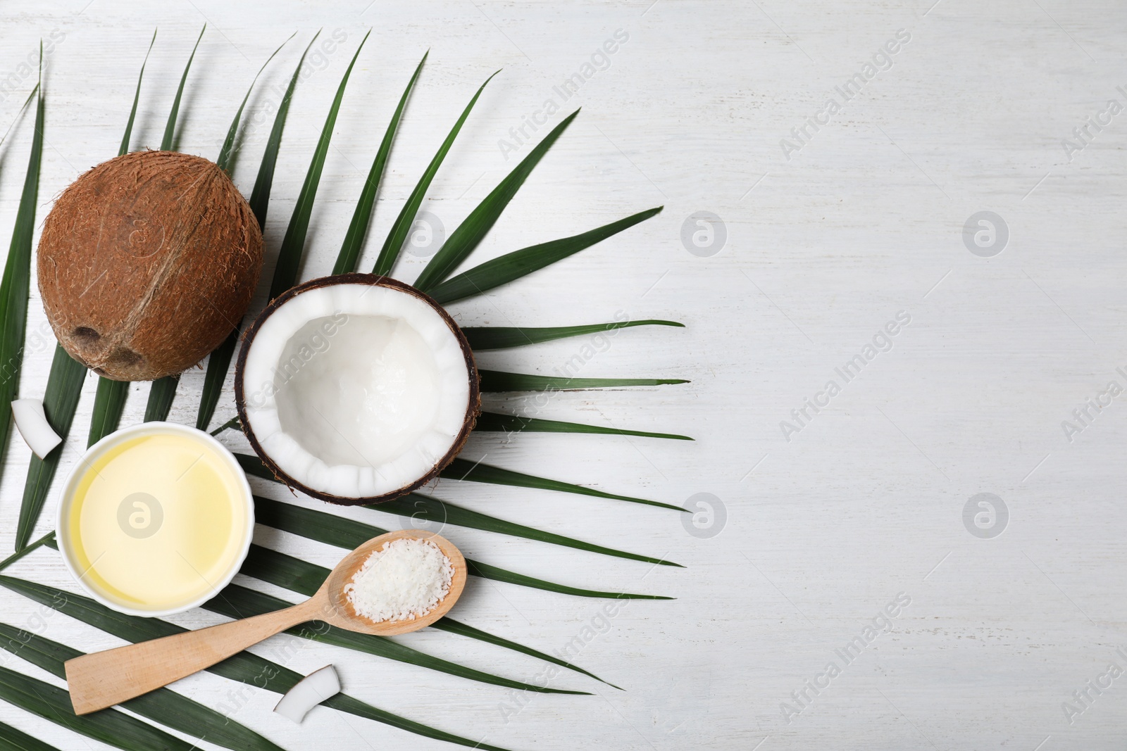 Photo of Flat lay composition with natural organic coconut oil on wooden background. Space for text