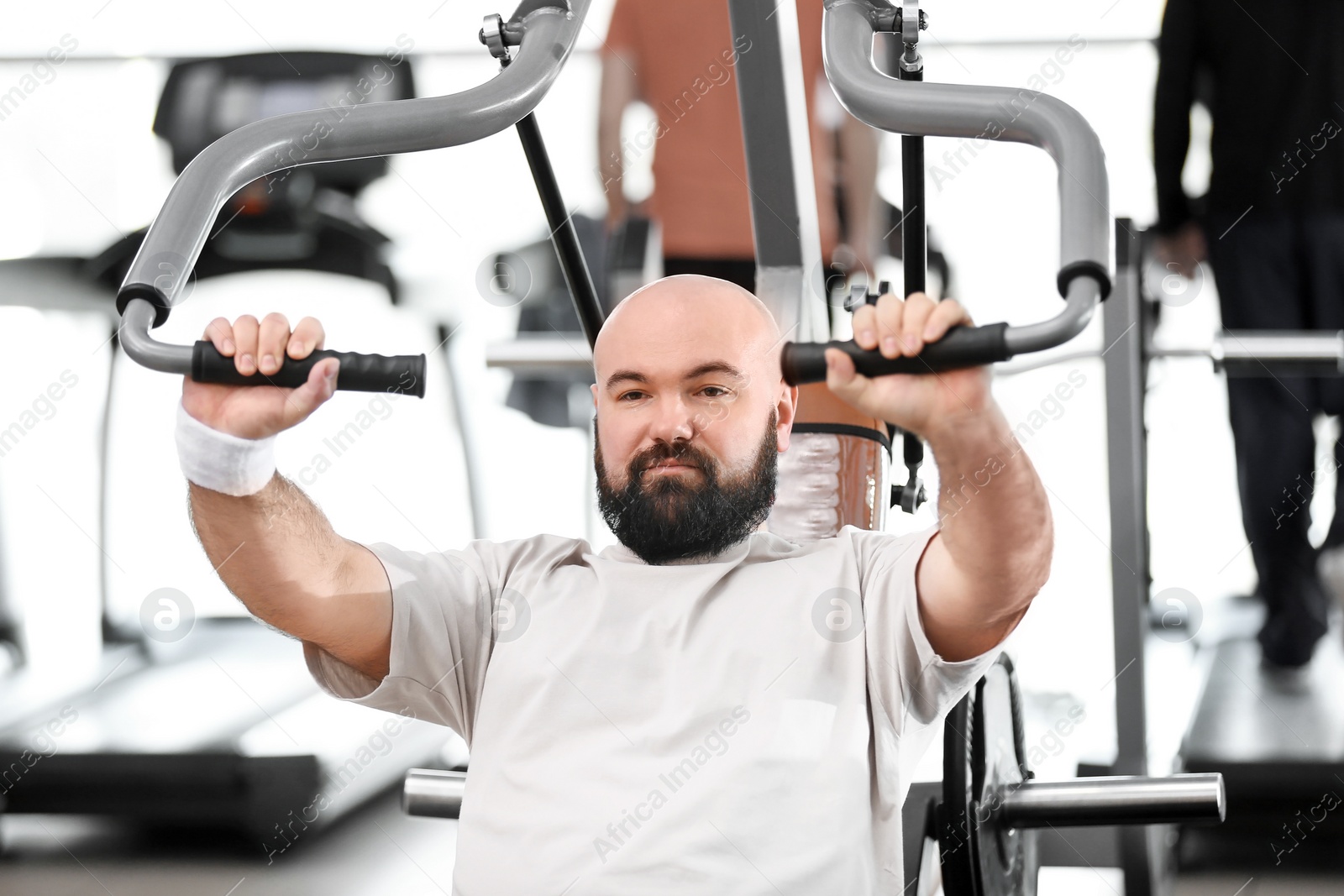 Photo of Overweight man training in gym