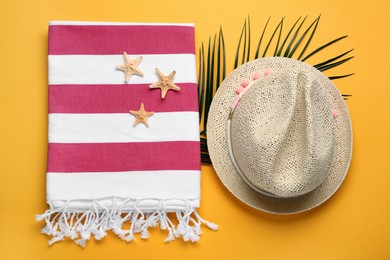 Photo of Flat lay composition with different beach objects on orange background